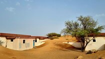 The Ghost Village Safari Tour with Dune Bashing and Sandboarding