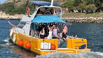 Boat tour with lunch on board and swimming near a beach in Lisbon