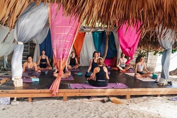 Sunrise yoga class overlooking the beach, the sea & sunrise .